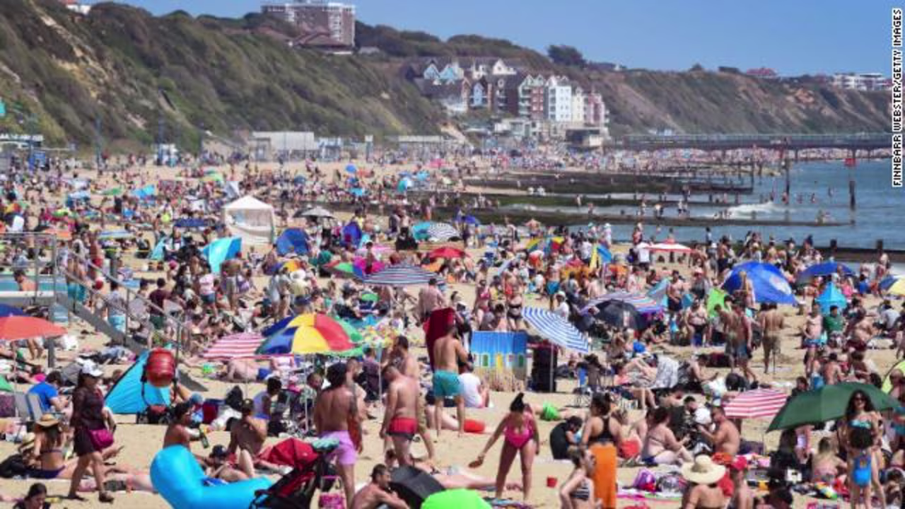 Tourists enjoy the hot weather at Bournemouth beach on May 25, after some coronavirus restrictions were eased.