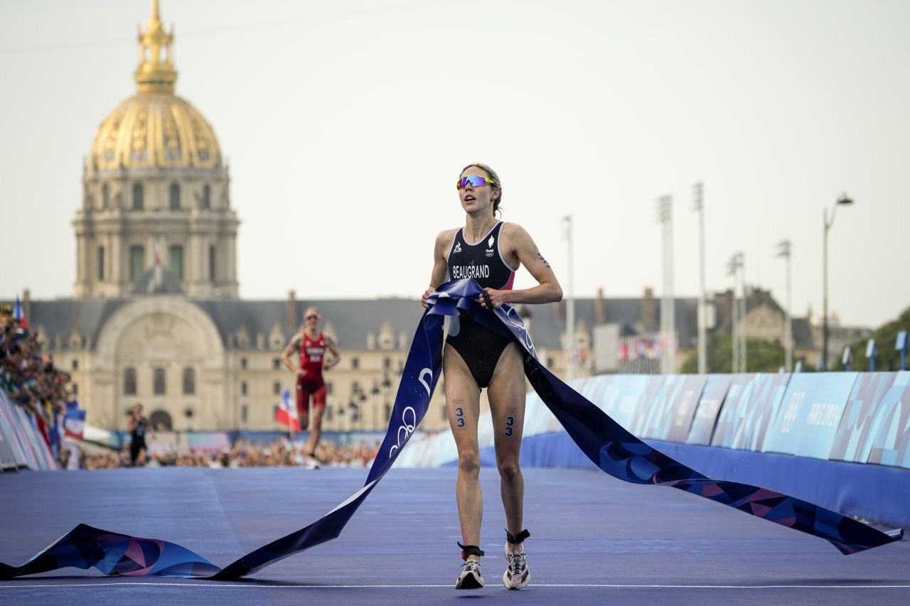 France's Cassandre Beaugrand celebrates after winning the women's individual triathlon competition at the 2024 Summer Olympics, on July 31, in Paris, France.