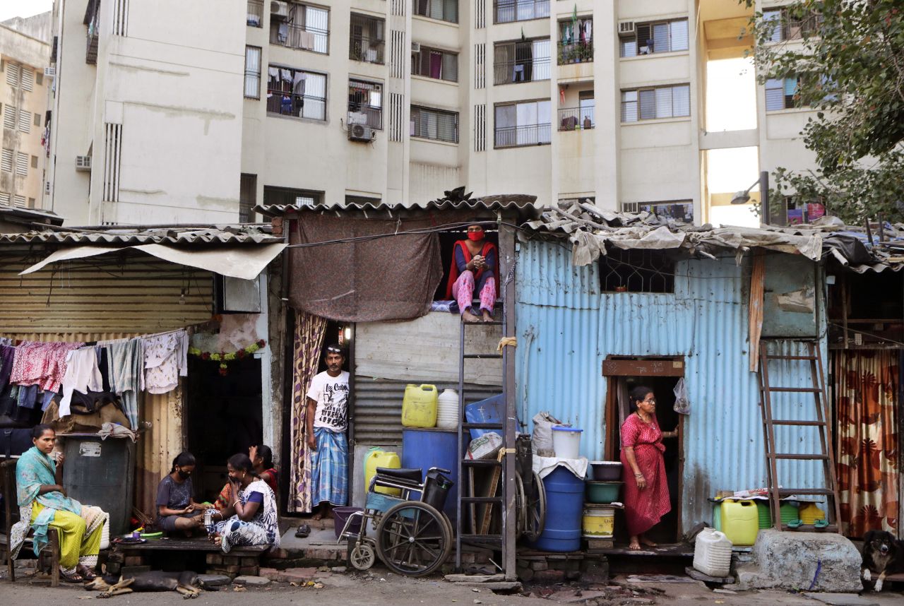 People rest by their homes in Dharavi, one of Asia's largest slums, in Mumbai, India, on April 3.