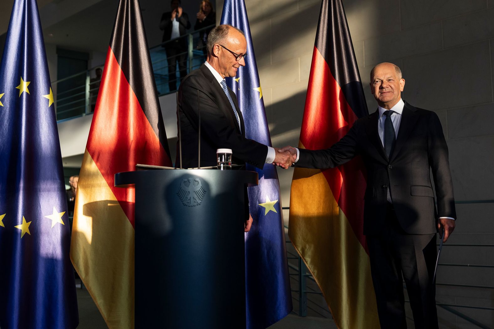 Outgoing German Chancellor Olaf Scholz, right, congratulates <a href="index.php?page=&url=https%3A%2F%2Fwww.cnn.com%2F2025%2F05%2F06%2Feurope%2Fmerz-chancellor-german-parliament-intl">new Chancellor Friedrich Merz</a> during a handover ceremony in Berlin on Tuesday, May 6.