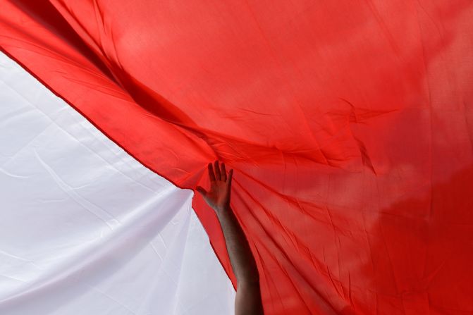 A man holds a Polish flag during a march in Warsaw, Poland, showing support for presidential candidate Rafal Trzaskowski on Sunday, May 25. Trzaskowski and Karol Nawrocki will face off in a <a  target="_top" href="/newspapers?url=https://www.cnn.com/2025/05/19/europe/poland-election-trzaskowski-second-round-intl">second round of the election</a> on June 1.