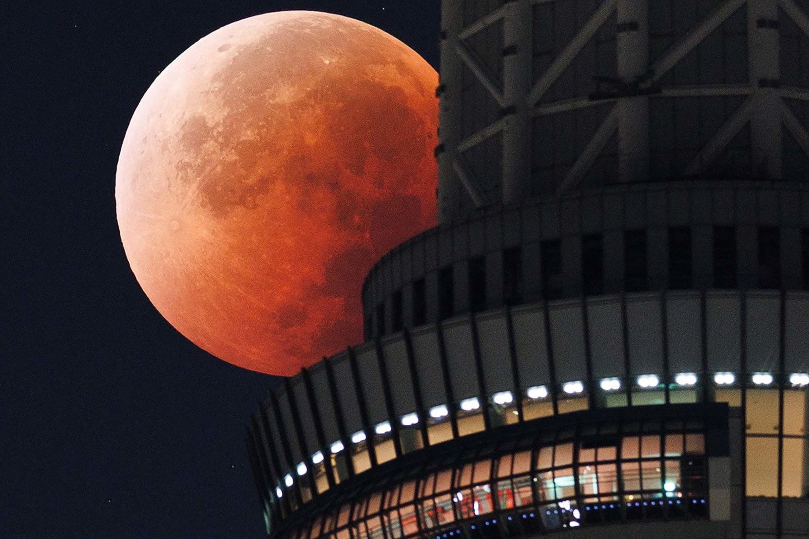 The moon is seen behind the Tokyo Skytree during a <a href="index.php?page=&url=https%3A%2F%2Fwww.cnn.com%2F2025%2F09%2F08%2Fscience%2Fgallery%2Fin-pictures-blood-moon-rises">total lunar eclipse</a> early on Monday, September 8.