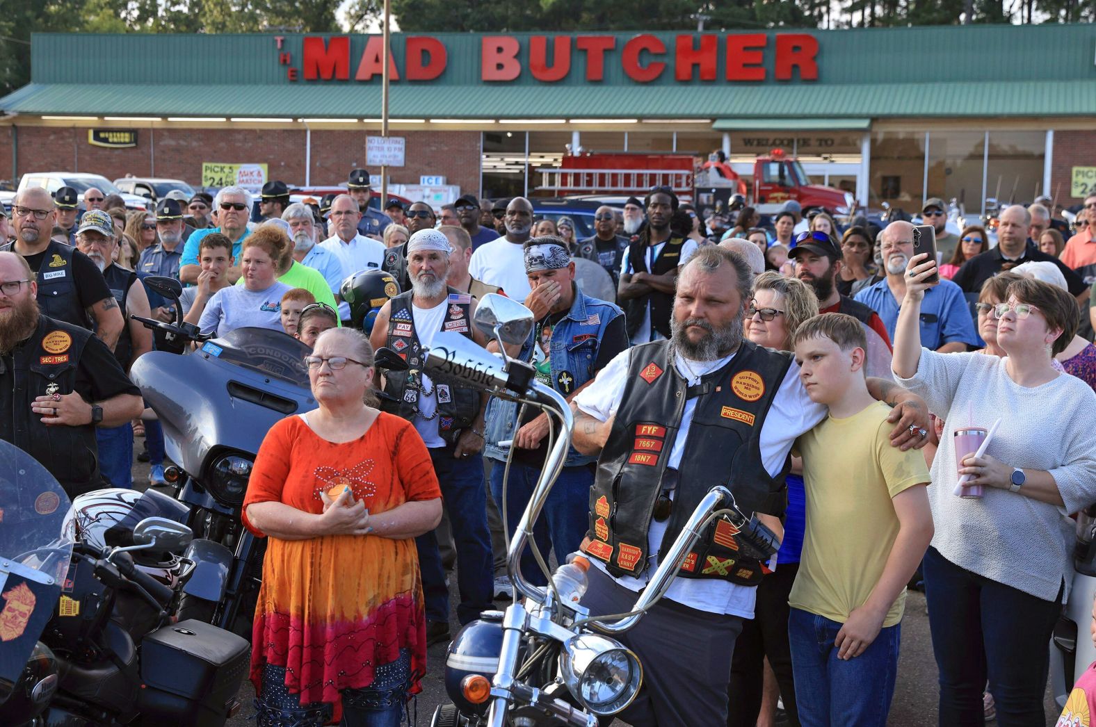 Mourners gather in the parking lot of the Mad Butcher grocery store for a candlelight vigil honoring the victims of a <a href="index.php?page=&url=https%3A%2F%2Fwww.cnn.com%2F2024%2F06%2F22%2Fus%2Ffordyce-arkansas-grocery-store-shooting-saturday%2Findex.html">mass shooting</a> in Fordyce, Arkansas, on Sunday, June 23. Four people were killed and nine were wounded. The suspected shooter was also wounded and taken into custody.