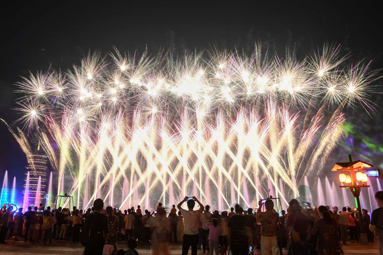 Visitors watch as fireworks explode over the Ancient Town of Tong Guan Kiln in Changsha, Hunan province of China on May 3. 