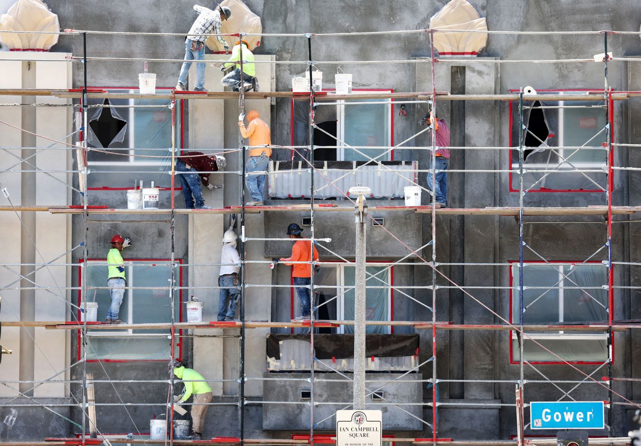 Construction workers stand on scaffolding while building residential housing on July 12, 2023 in Los Angeles, California.