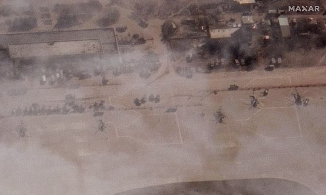A satellite image from Maxar Technologies shows a number of Russian military helicopters sitting on the tarmac at the airport on Monday. 