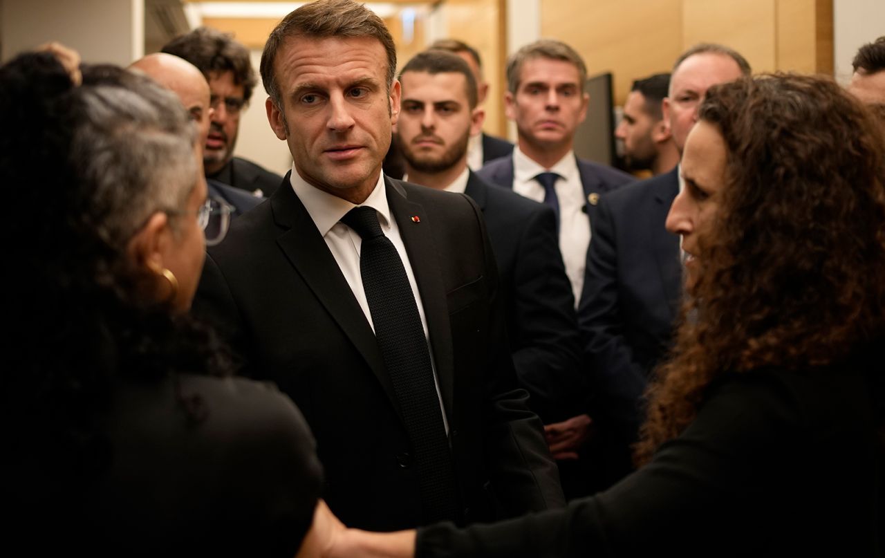 Emmanuel Macron meets with Israeli-French nationals who have lost loved ones, as well as families of hostages, at the Ben Gurion airport, in Tel Aviv on October 24.