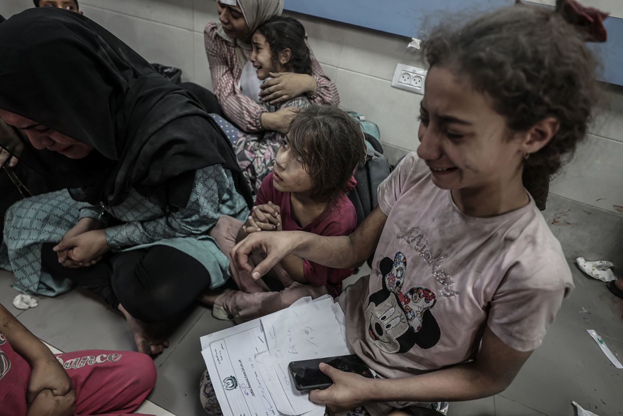 Women and children huddle together on the floor of the Al-Shifa Hospital in Gaza City following the blast.