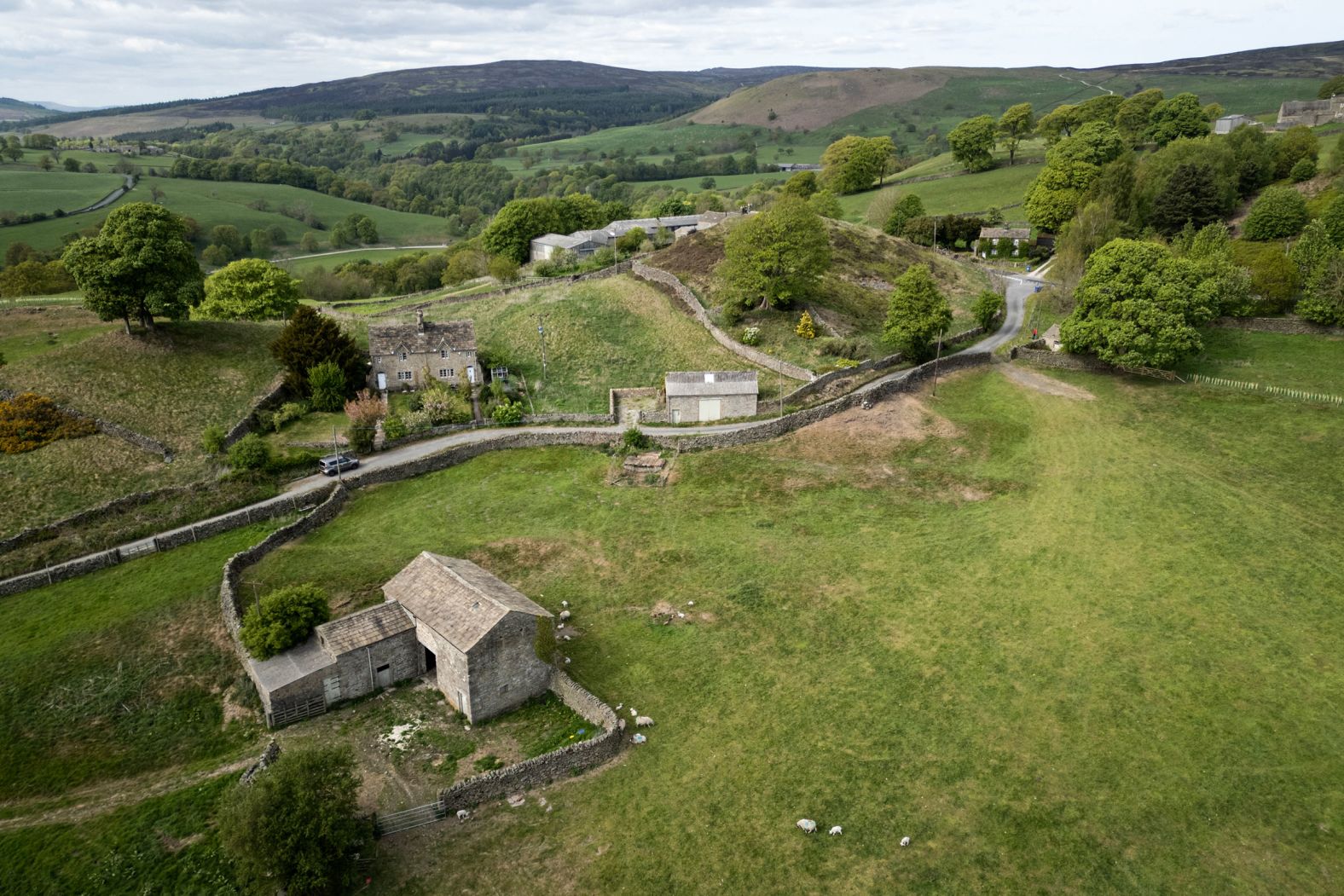 This aerial photo, taken on Tuesday, May 6, shows stone barns and cottages near the village of Bolton Abbey in northern England.