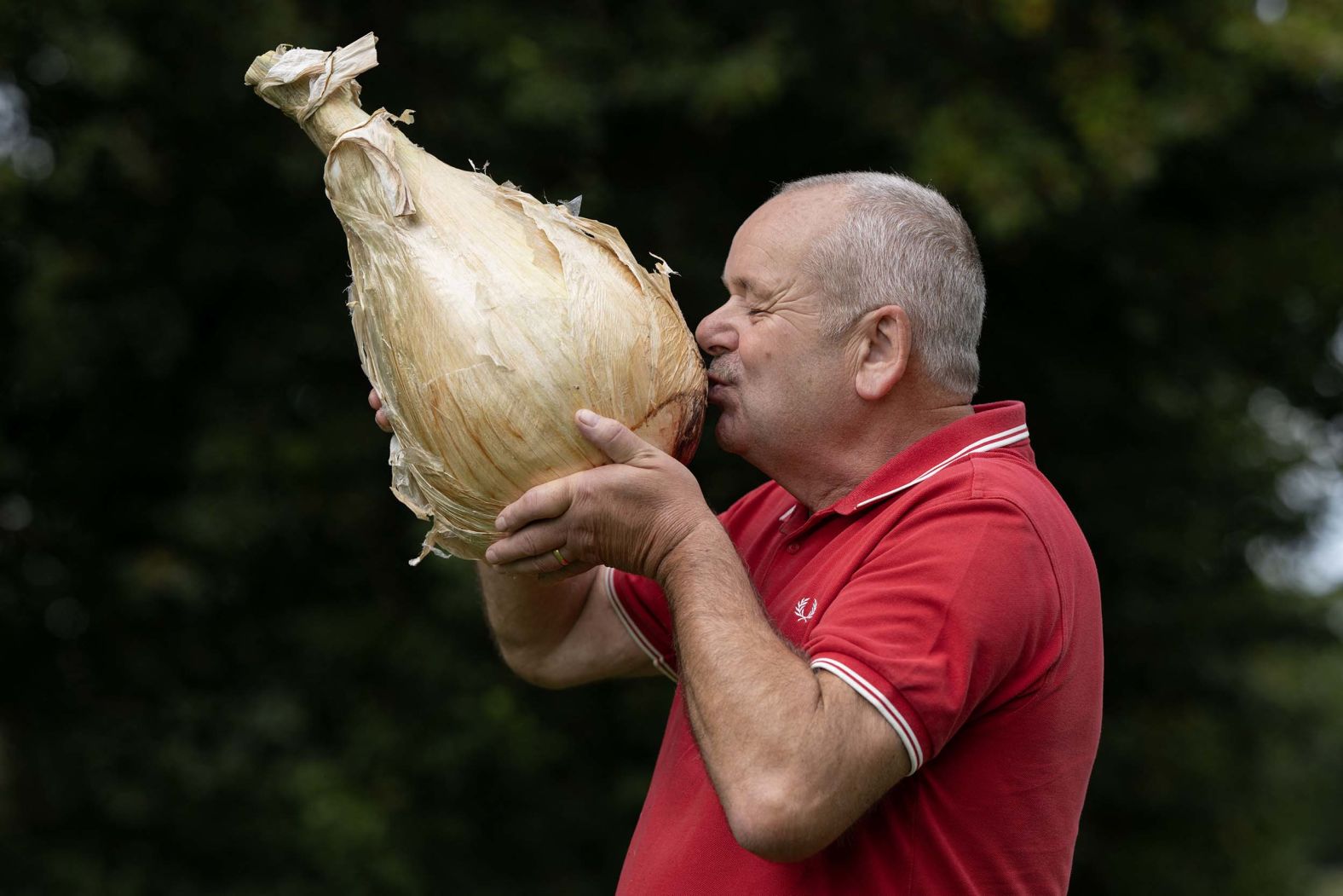 Stephen Purvis poses with his 8.8-kilogram (19.4-pound) onion that won heaviest onion during the Harrogate Autumn Flower Show near Ripon, England, on Friday, September 19.