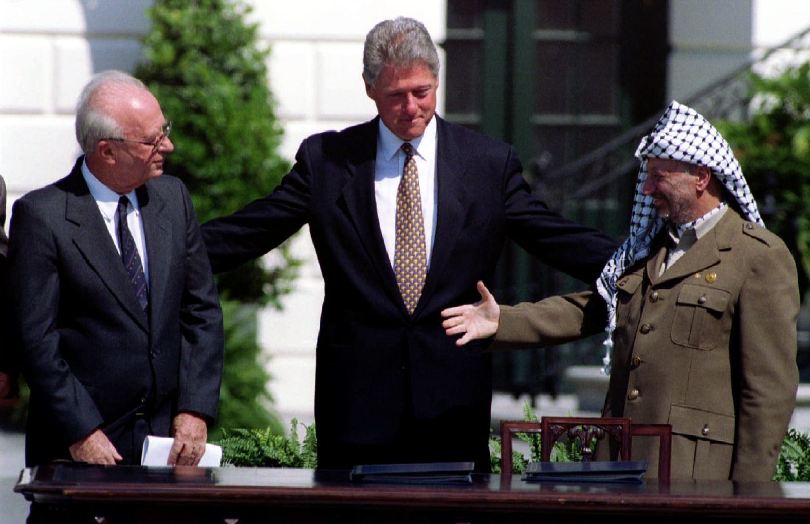 US President Bill Clinton brings together Israeli Prime Minister Yitzhak Rabin, left, and Palestinian leader Yasser Arafat for their historic handshake after the signing of the Oslo Accords in Washington, DC, on September 13, 1993. Arafat extended his hand first to Rabin. “There was this awkward hesitation where Rabin is just looking at him, and Arafat has this Cheshire cat grin on his face,” photographer Rick Wilking remembered. “To me that was the most powerful image to come out of that, because it sort of summed up the attitudes at the time — do I really want to shake hands with this guy who’s been my enemy forever?”