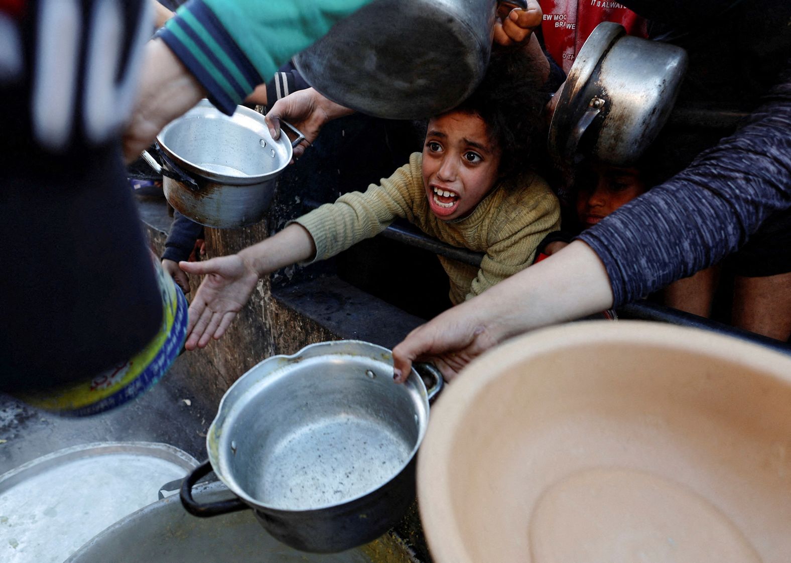 Palestinians in Rafah, Gaza, wait to receive food during the Muslim holy month of Ramadan on March 13.