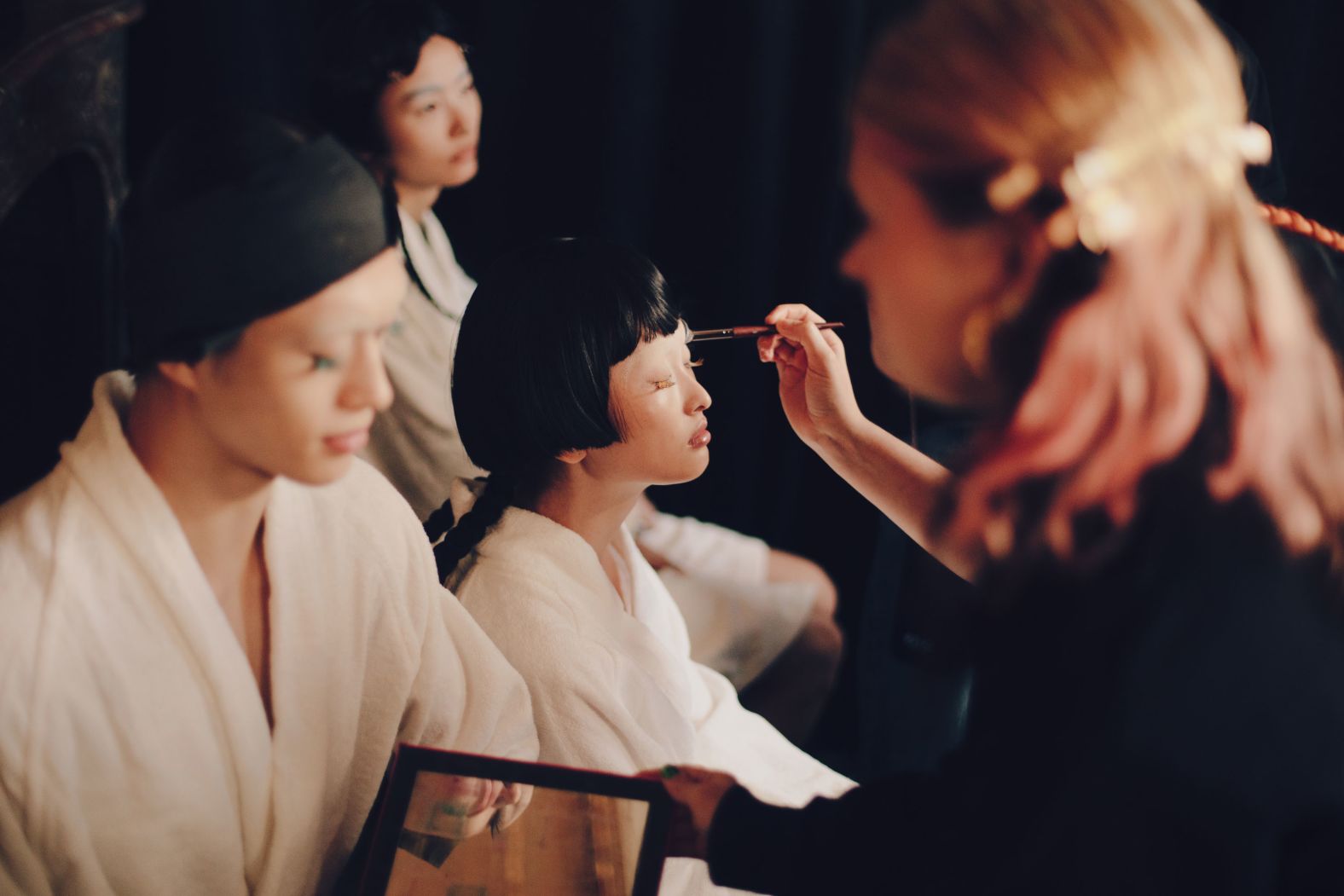 A makeup artist prepares a model backstage at a Thom Browne show during <a href="index.php?page=&url=https%3A%2F%2Fwww.cnn.com%2Fstyle%2Fparis-fashion-week">Paris Fashion Week</a> on Monday, October 6.