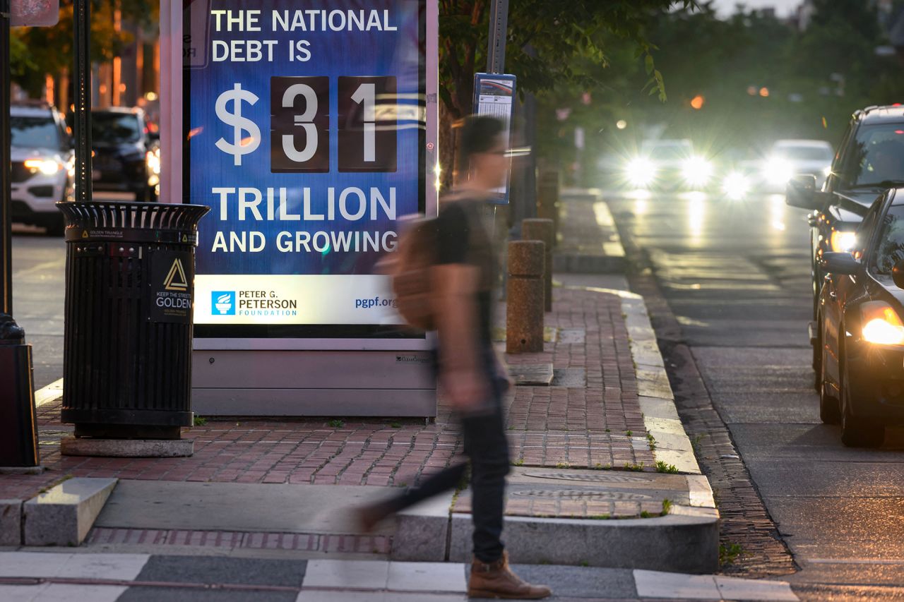 A poster at a bus shelter shows the national debt in Washington, DC, on May 21.