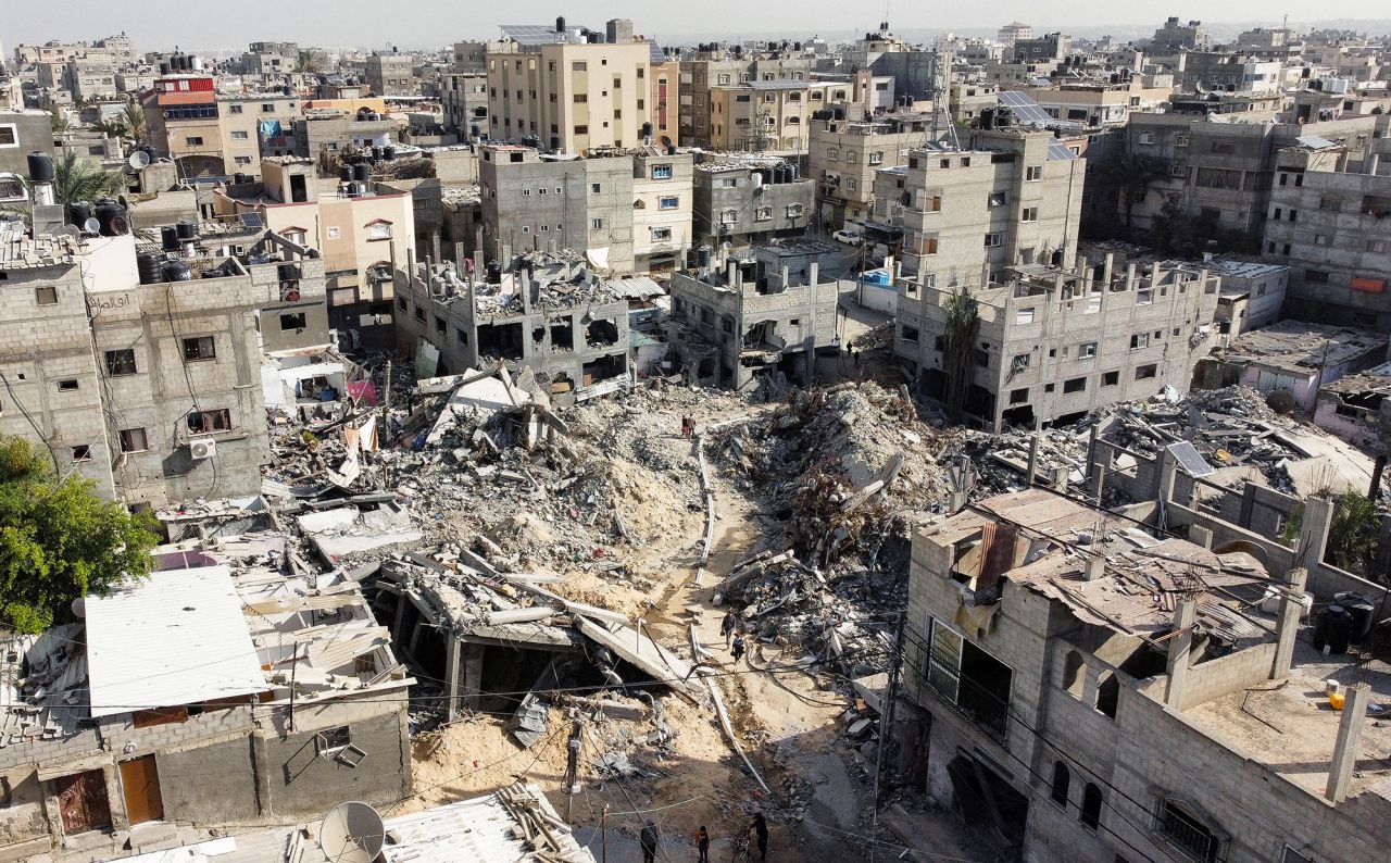 Palestinians walk among the rubble as they inspect houses destroyed by Israeli strikes, amid the temporary truce between Hamas and Israel, in Khan?Younis, Gaza, on November 27.