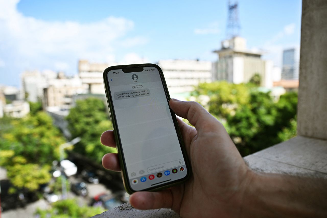 A Lebanese man checks a message received on his mobile phone in Beirut, Lebanon, on September 23.