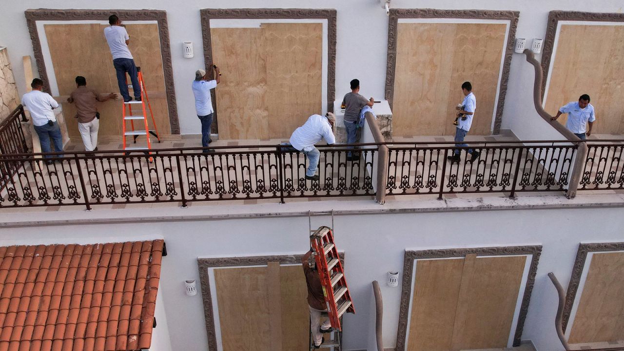 A drone view shows workers installing wood boards to cover glass doors in a hotel ahead of the arrival of Hurricane Beryl, in Playa del Carmen, Mexico, on July 3.