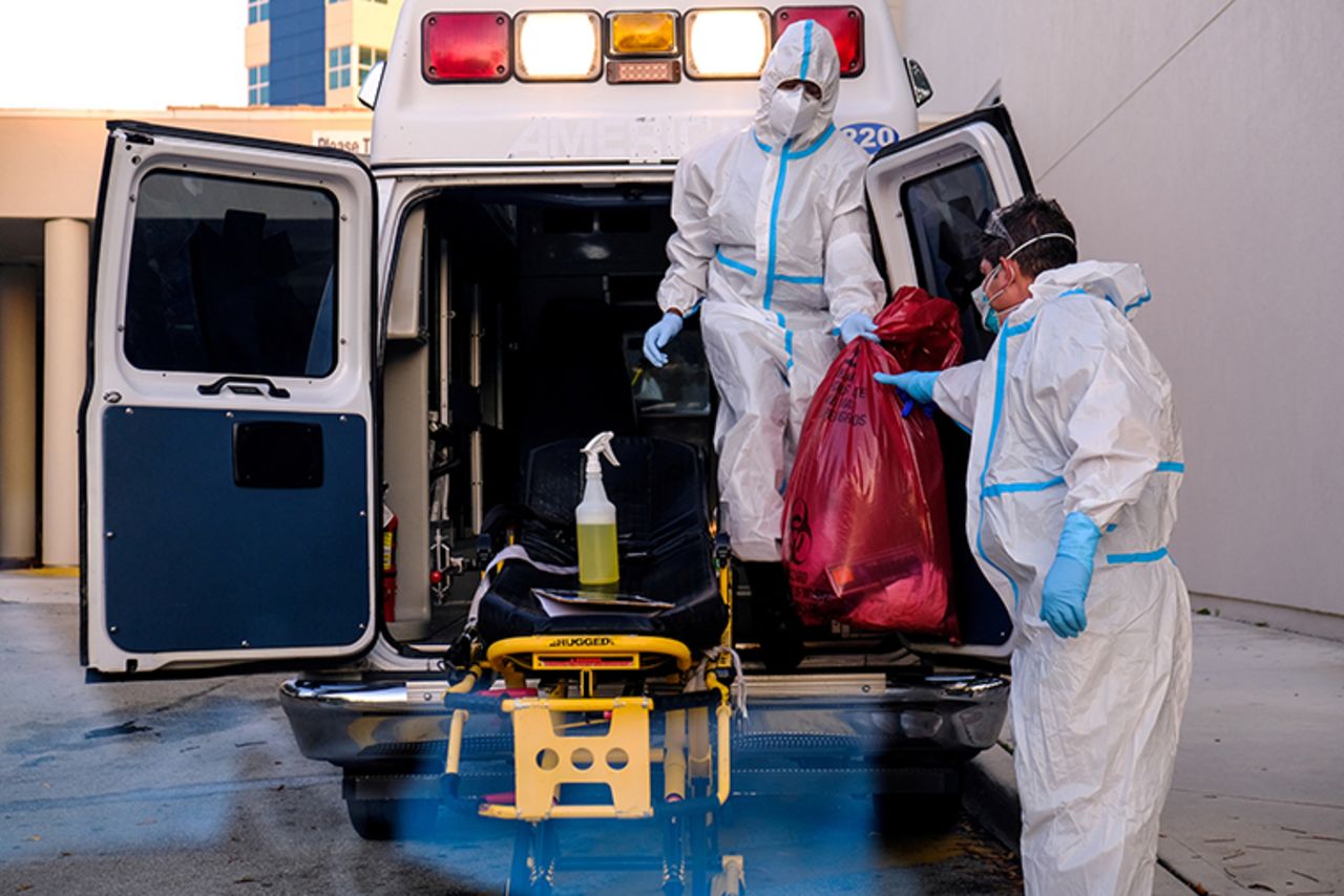 EMTs cleanse their materials outside Memorial West Hospital where coronavirus disease (COVID-19) patients are treated, in Pembroke Pines, Florida, on July 13. 