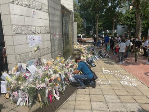 Tributes were paid outside the British Consulate in Hong Kong on Monday.