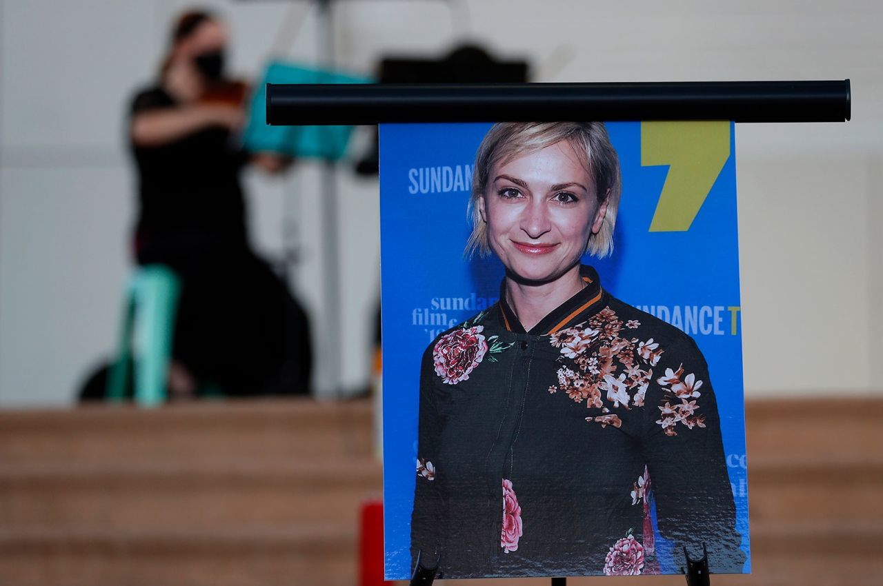 A musician plays a violin behind a photograph of cinematographer Halyna Hutchins during a vigil in her honor in Albuquerque, New Mexico, in October 2021. 