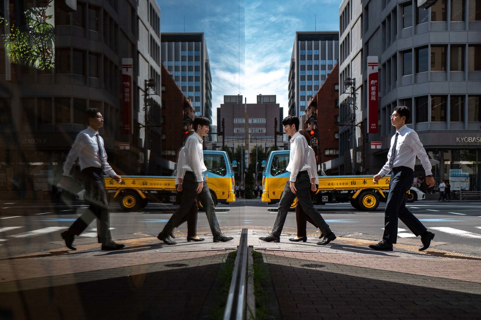 Pedestrians are reflected in glass as they walk in the Ginza district of Tokyo on Wednesday, October 8. <a href="index.php?page=&url=https%3A%2F%2Fwww.cnn.com%2F2025%2F09%2F25%2Fworld%2Fgallery%2Fphotos-this-week-september-18-september-25">See last week in 38 photos</a>.