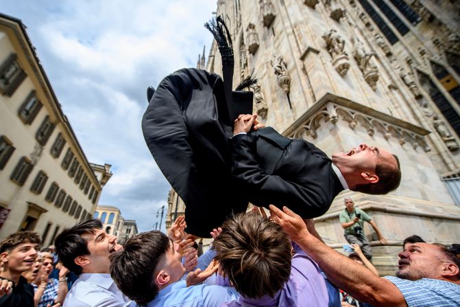 A newly ordained priest is thrown into the air in celebration after a service in Milan, Italy, on Saturday, June 7.