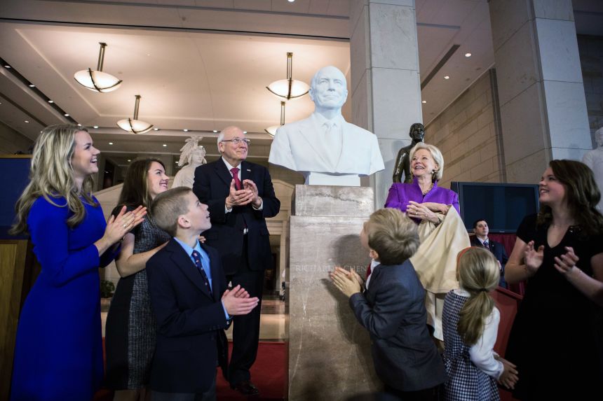 Cheney, alongside his wife and family, look at the bust of the former vice president after it was unveiled at Emancipation Hall inside the Capitol on December 3, 2015.