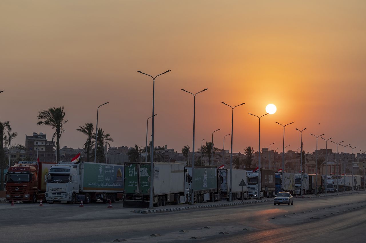 Aid convoy trucks loaded with supplies are seen waiting for the Gaza-Egypt border to open on 15 October, in North Sinai, Egypt.