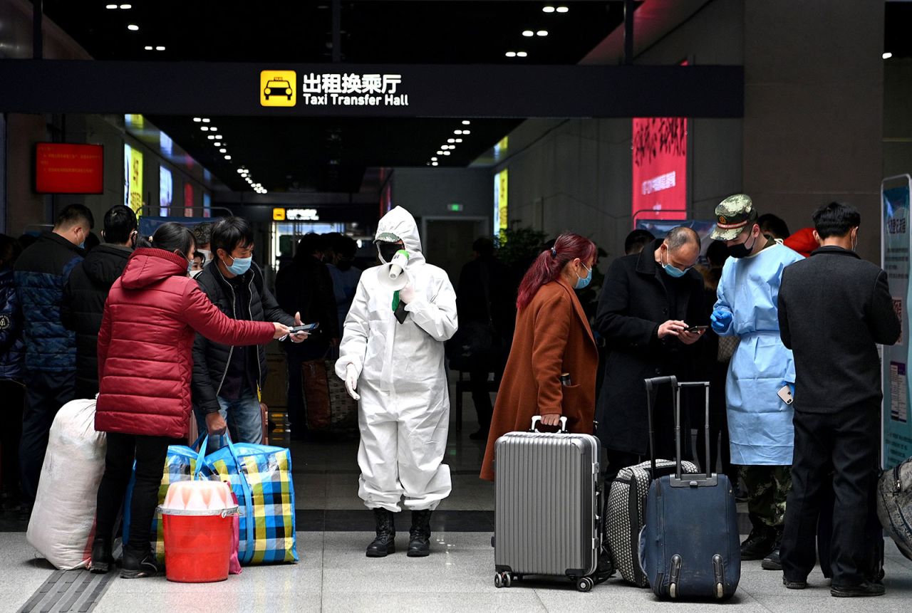 Passengers wearing face masks have their travel history checked as they arrive at the railway station in Hefei, China on March 4.