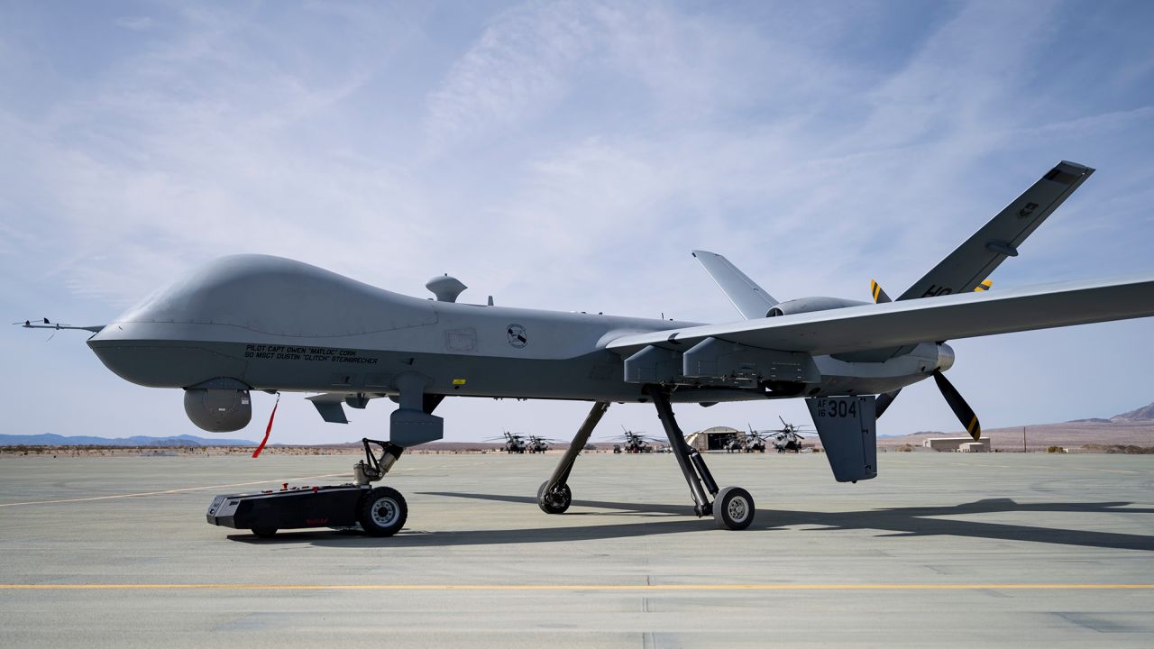 A TowFLEXX TF3 aircraft tug hauls an MQ-9 Reaper along a runway at Marine Corps Air Ground Combat Command Center, Twentynine Palms, California, on February 16.