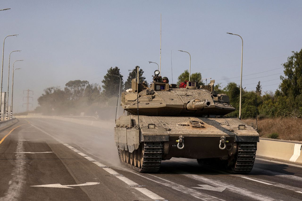 An Israeli tank travels on a highway near Sderot, Israel, on October 8. 