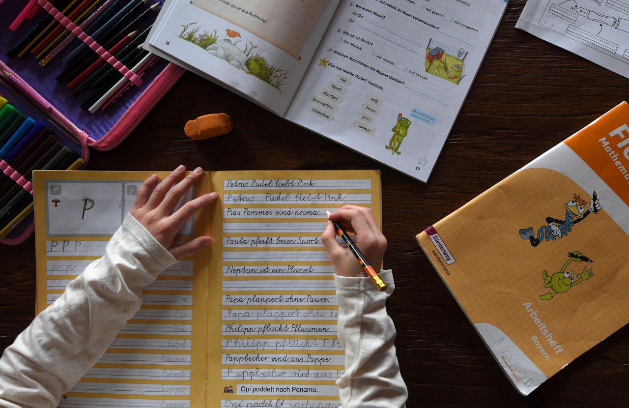 A girl studies at her home in Eichenau, Germany, on March 17, as schools close due to the novel coronavirus outbreak.