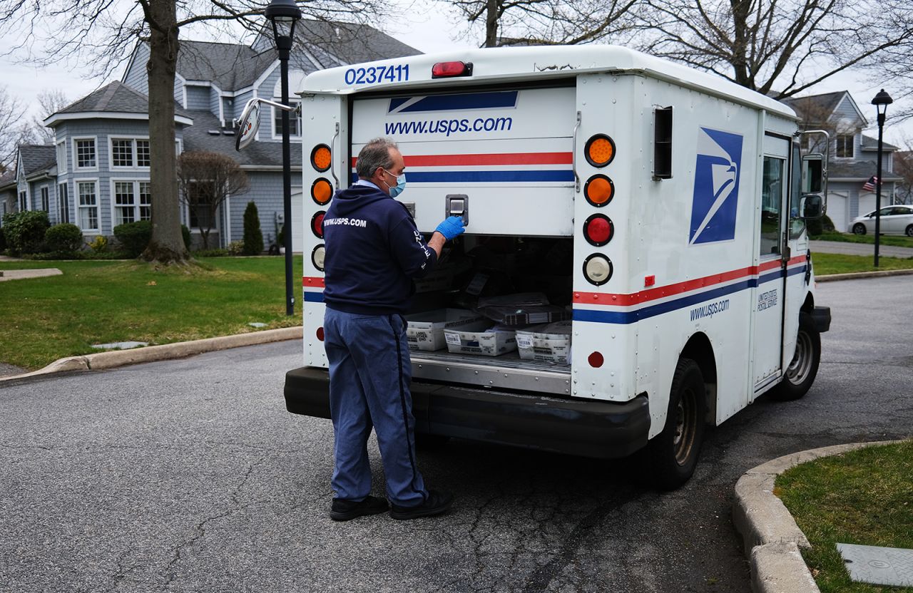 US Postal Service worker Lou Martini goes about his daily delivery route during the coronavirus pandemic on April 15, in Kings Park, New York. 