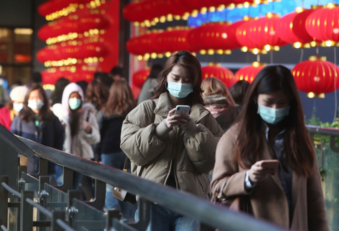 People wear face masks and walk at a shopping mall in Taipei, Taiwan, Friday, January 31.