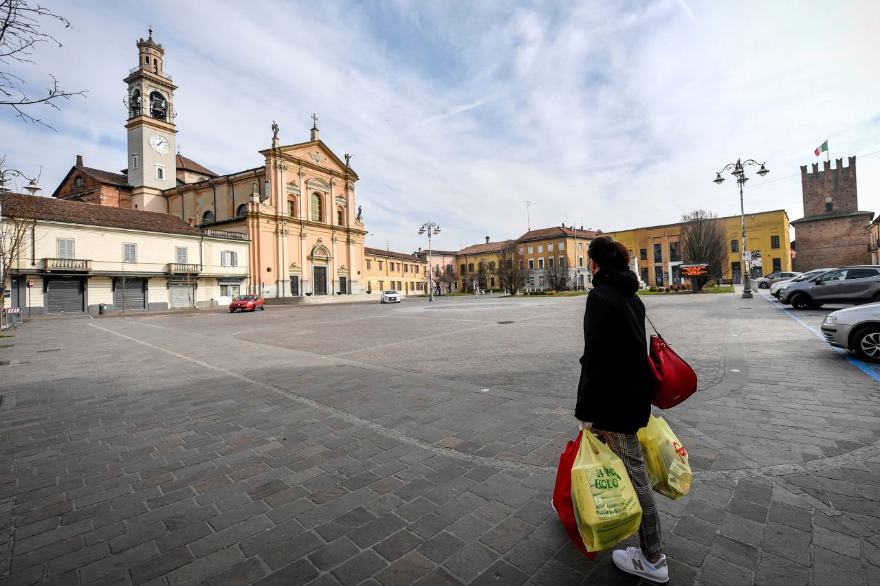 A woman carries shopping bags in Casalpusterlengo on Sunday. 