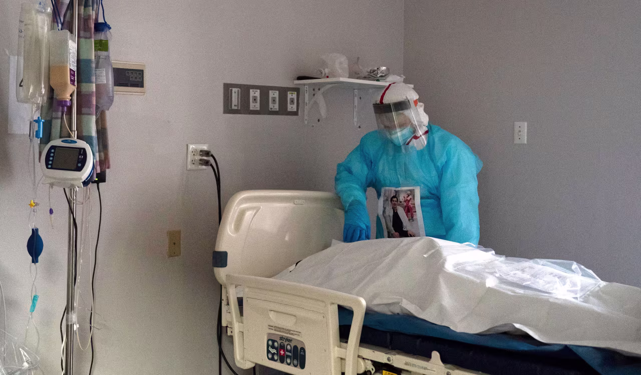 Medical staff member Gabriel Cervera Rodoriguez stands next to a deceased patient in the Covid-19 Intensive Care Unit of United Memorial Medical Center on December 11 in Houston, Texas. 