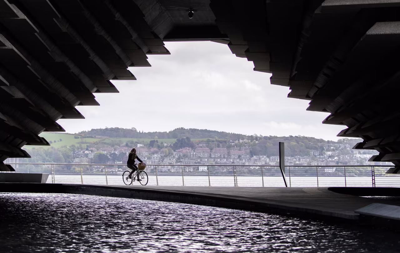 A cyclist passes the closed V&A Museum in Dundee, Scotland as the United Kingdom continues in lockdown to help curb the spread of the coronavirus on May 3. 