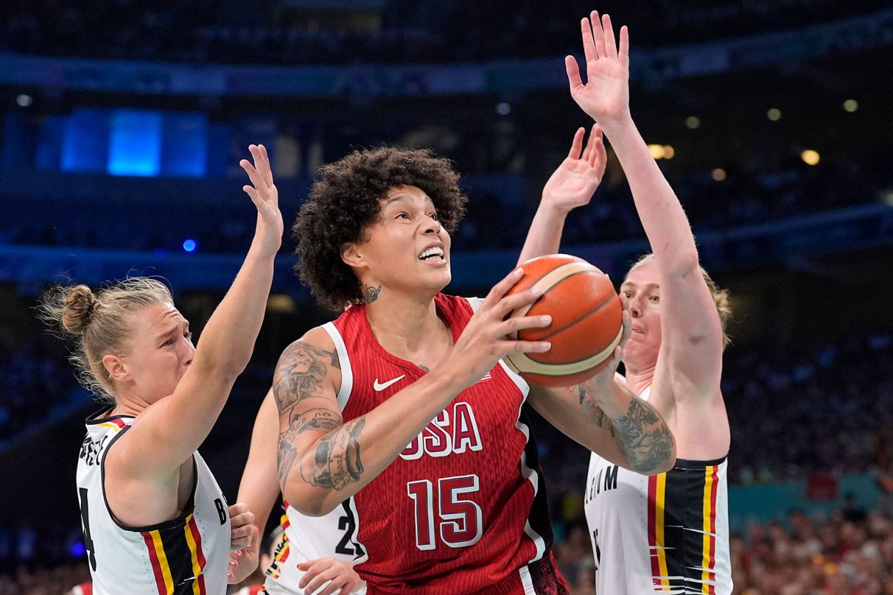 Brittney Griner, center, shoots as Belgium's Elisa Ramette and Belgium's Emma Meesseman defend during a women's basketball game at the 2024 Summer Olympics, Thursday, August 1, in Villeneuve-d'Ascq, France. 