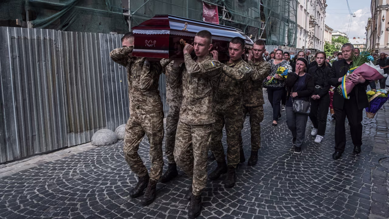 Ukrainian soldiers carry the coffins of the fallen during the funeral in Lviv, Ukraine on May 26.
