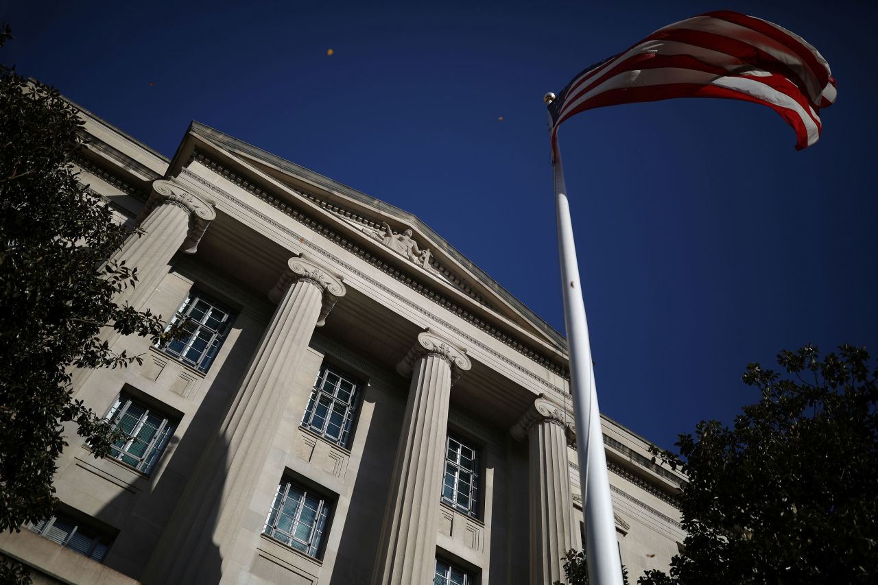 An American flag waves outside the US Department of Justice Building in Washington, DC in 2020. 