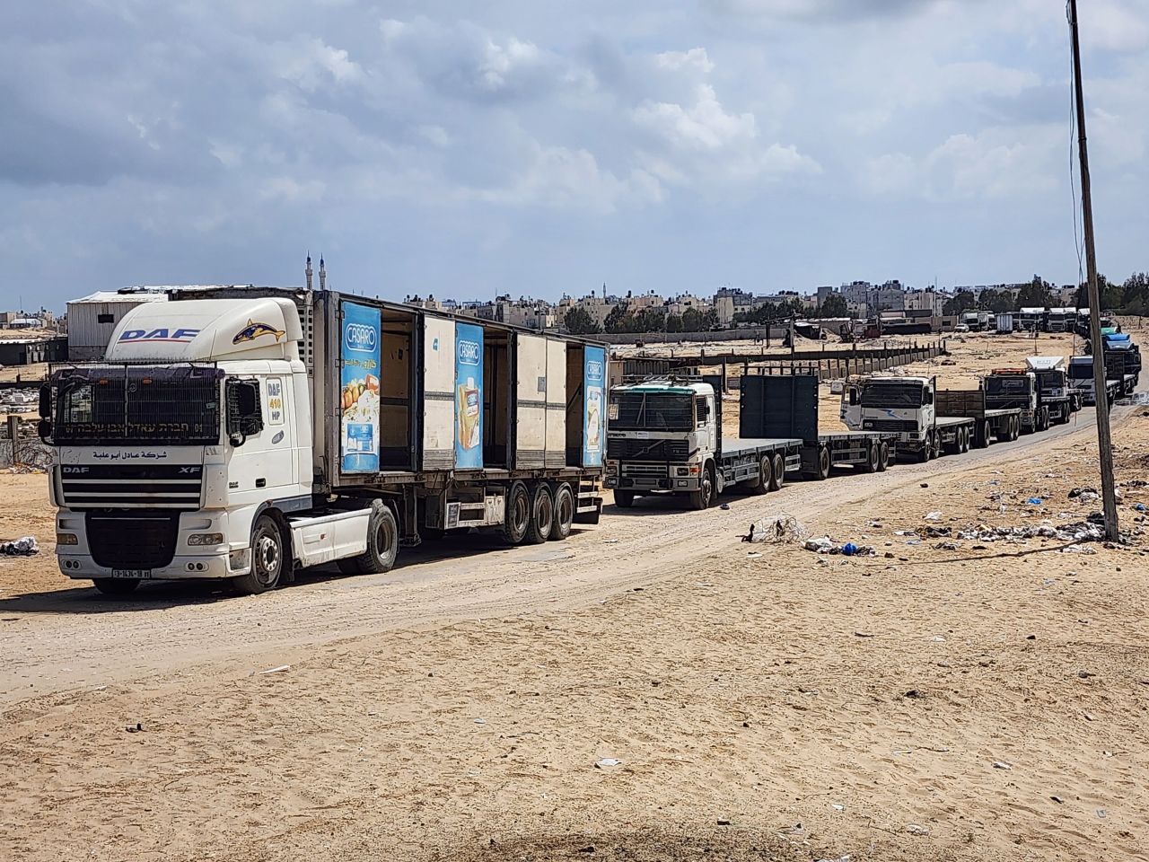 Palestinian truck drivers and United Nations vehicles wait near the Rafah border gate on the Gazan side to cross into the Egyptian side on Tuesday.