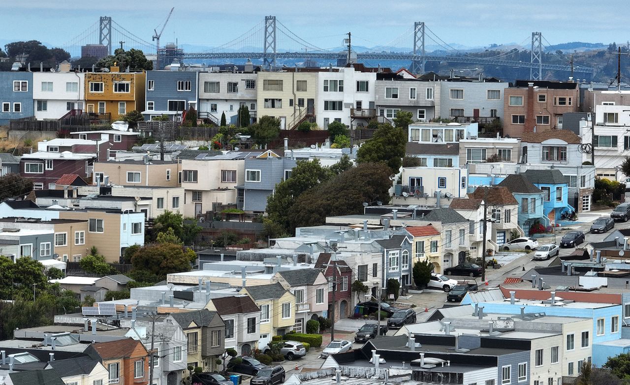 In an aerial view, homes stand in front of the Oakland-San Francisco Bay Bridge on June 9 in San Francisco, California. 