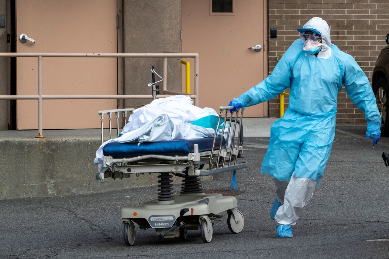 Medical personnel remove a body from the?Wyckoff Heights Medical Center to refrigerated containers parked outside, on April 2 in Brooklyn, New York.