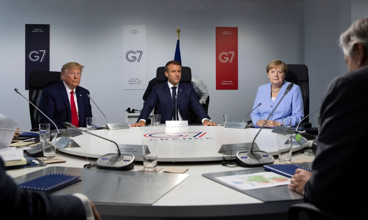 President  Trump, French President Emmanuel Macron and Germany's Chancellor Angela Merkel attend a work session at the  G7 Summit.