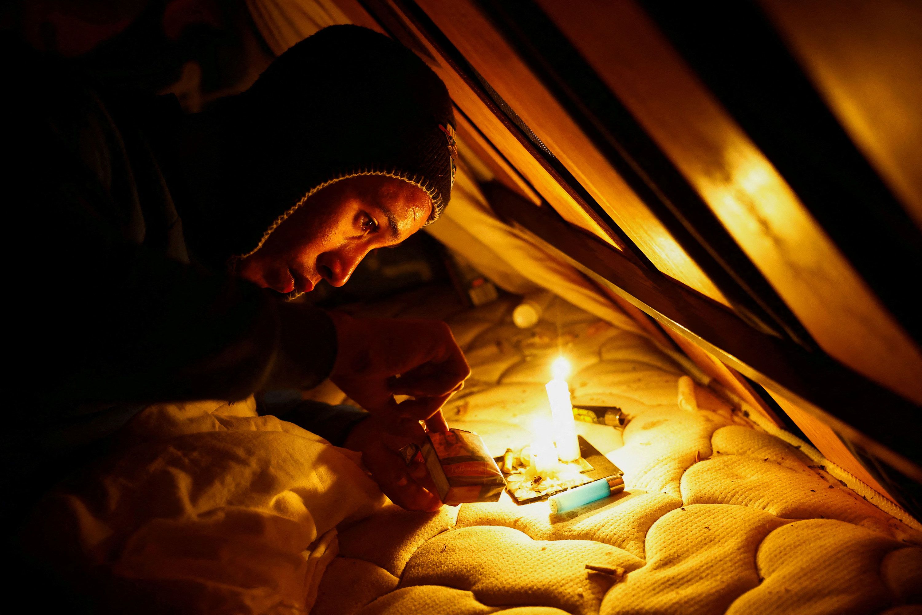 Moroccan migrant Abdellatif Bouhlal looks for a cigarette in the Arinaga ravine where he lives on the Spanish island of Gran Canaria on Thursday, July 11.