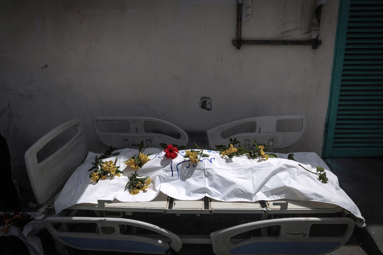 A body unearthed at Nasser Hospital is set on a stretcher and covered with flowers before being buried in Khan Younis, Gaza, on April 23. <a href="https://www.cnn.com/2024/04/25/middleeast/gaza-400-bodies-mass-grave-hospital-intl/index.html">Nearly 400 bodies were found in mass graves at the hospital</a> following Israeli troops’ withdrawal from the area earlier this month, the Palestinian Civil Defense in Gaza said. The Israel Defense Forces said any suggestion that it buried Palestinian bodies in mass graves was false, and that a grave at the Nasser complex was dug by Palestinians in Gaza some months ago.