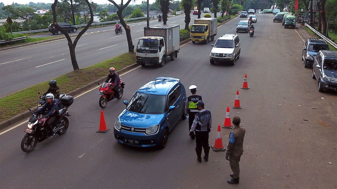 Vehicles drive past a checkpoint during a partial lockdown in Serpong, West Java, Indonesia, on April 24. 