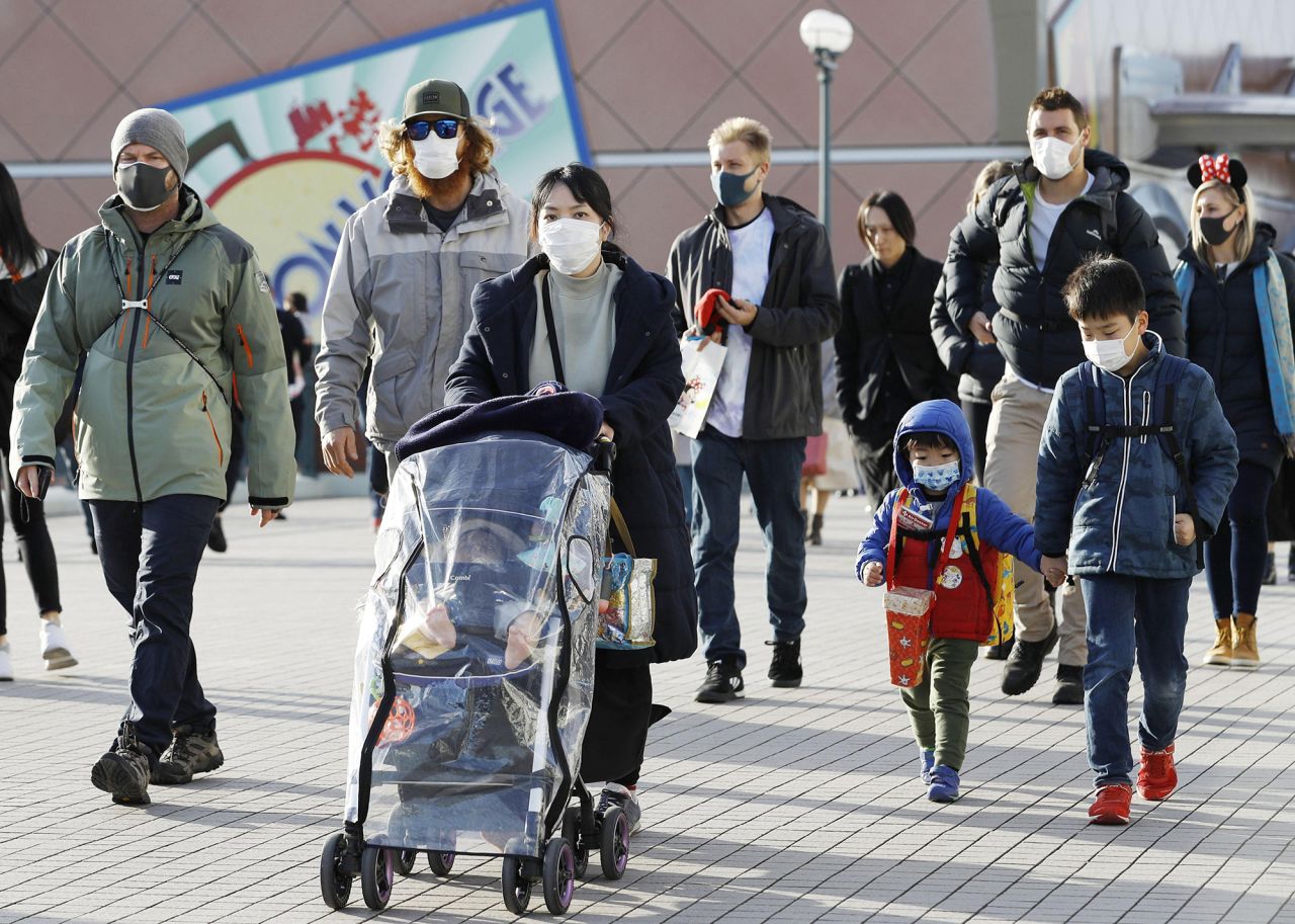 People wear masks near Tokyo Disneyland on February 2 amid the spreading coronavirus.