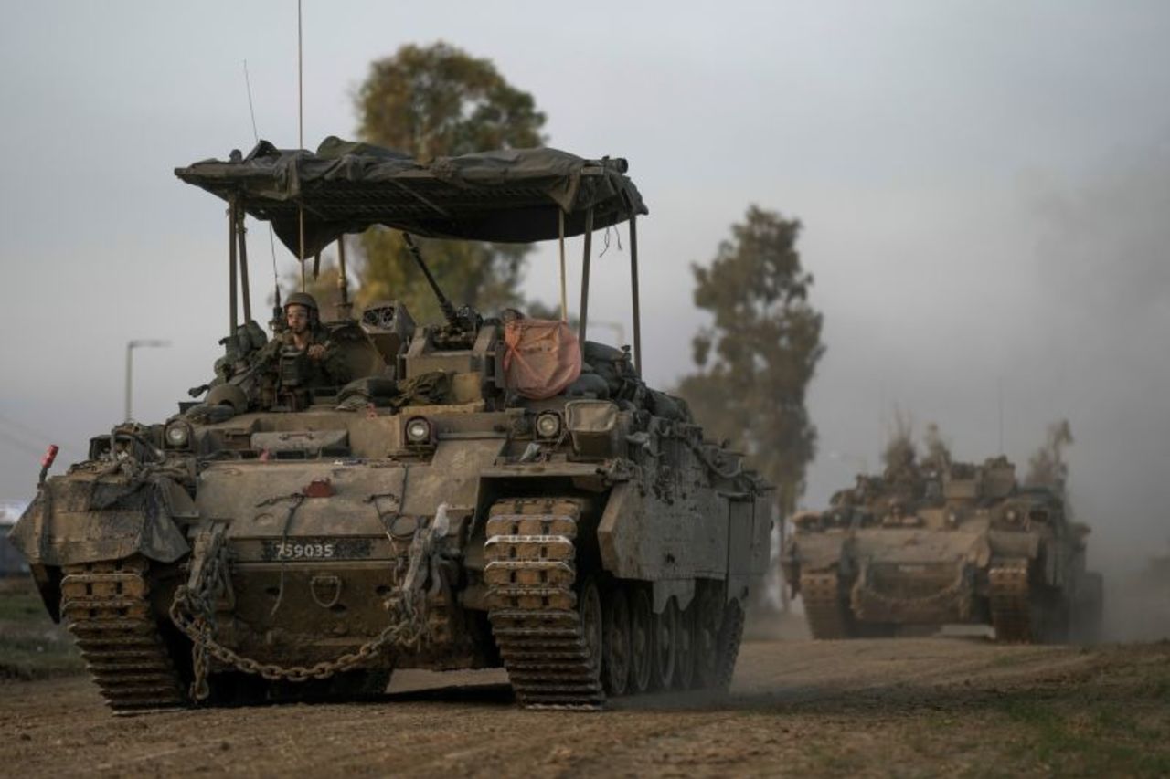 A Israeli army convoy moves near the Israel-Gaza border, in southern Israel, on December 25.