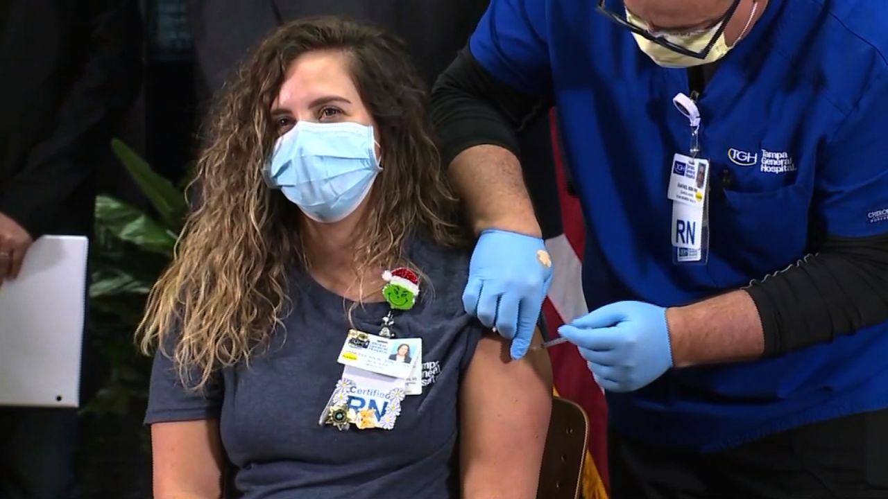 Vanessa Arroyo, a 31-year-old frontline nurse at Tampa General Hospital, receives the Pfizer-BioNTech Covid-19 vaccine during a news conference in Tampa, Florida, on December 14.